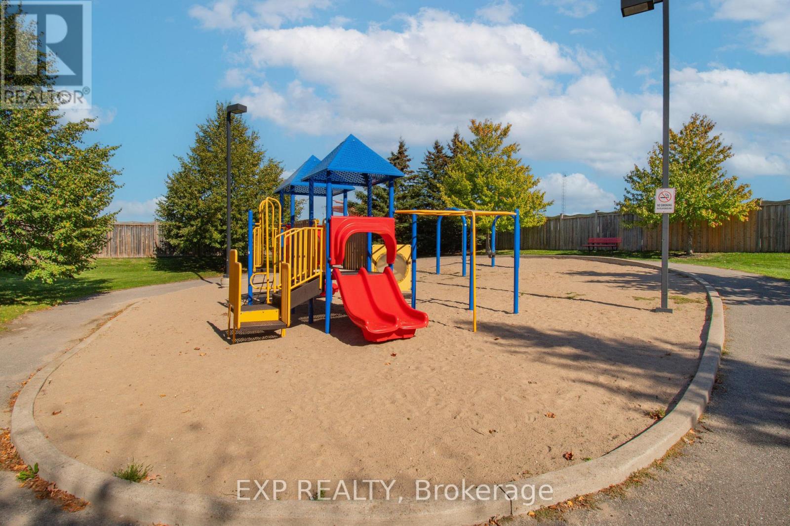 A playground with a blue canopy and a red slide.