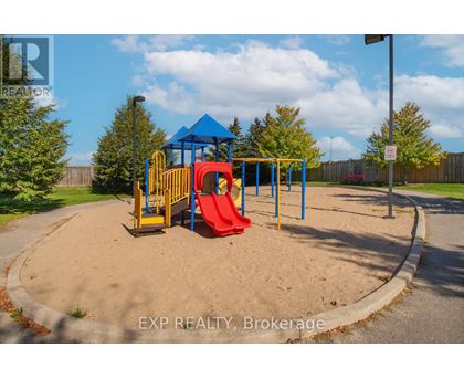 A playground with a blue canopy and a red slide.