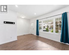 A room with a window and a door, with a sign that says "REALTOR".