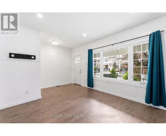 A room with a window and a door, with a sign that says "REALTOR".