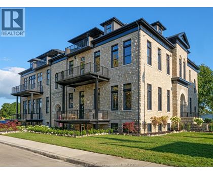 A large, multi-story building with a stone facade and balconies.