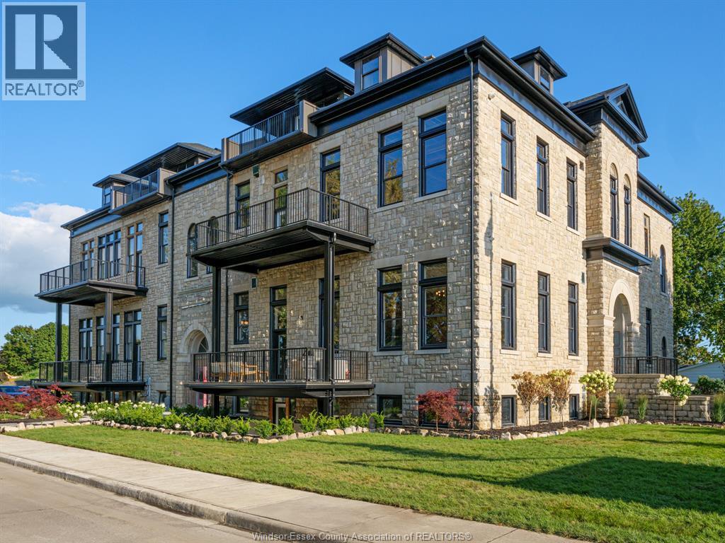 A large, multi-story building with a stone facade and balconies.
