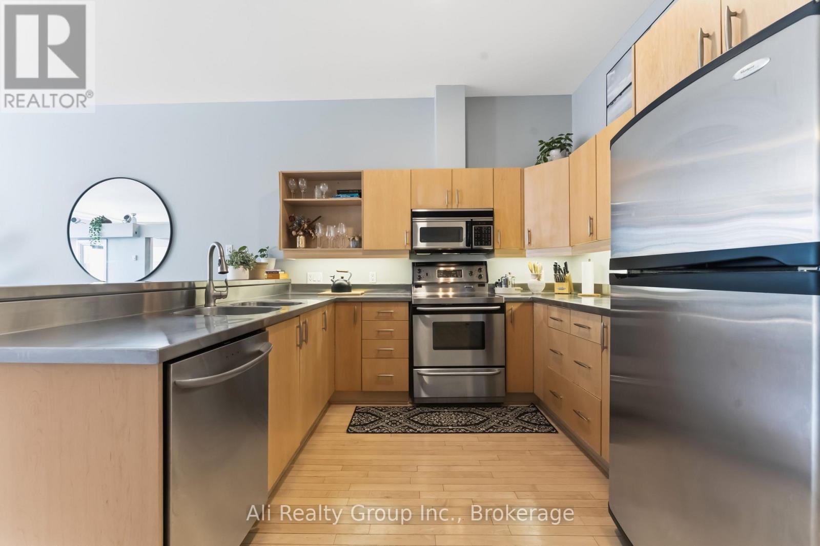 A modern kitchen with wooden cabinets and stainless steel appliances.