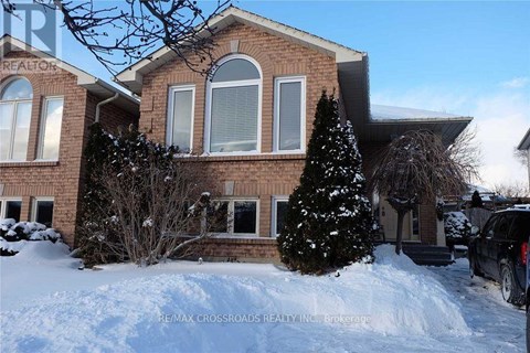 A house with a sign that says RE/MAX CROSSROADS REALTY INC. on the front.