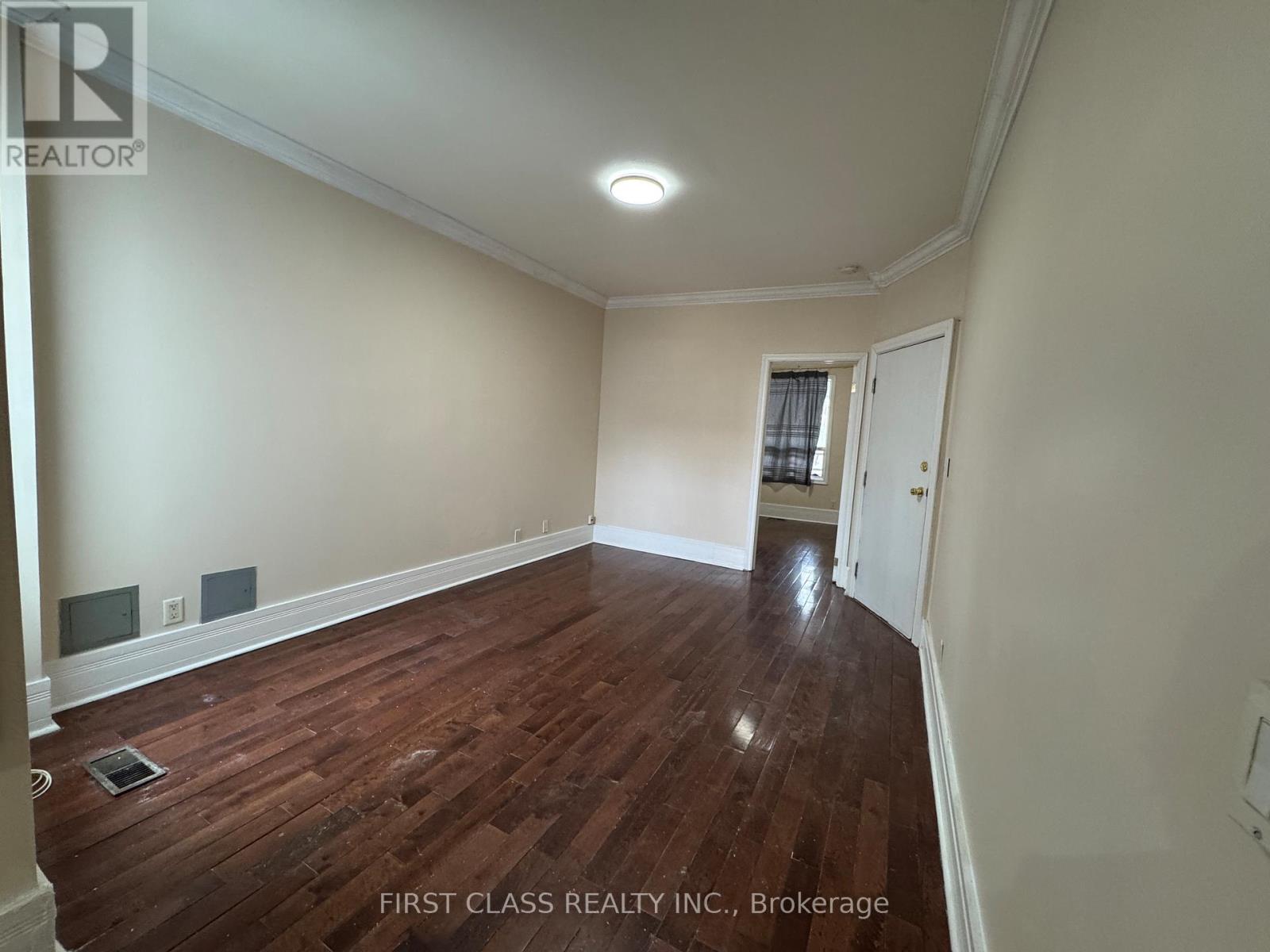 A room with wooden floors and white walls.