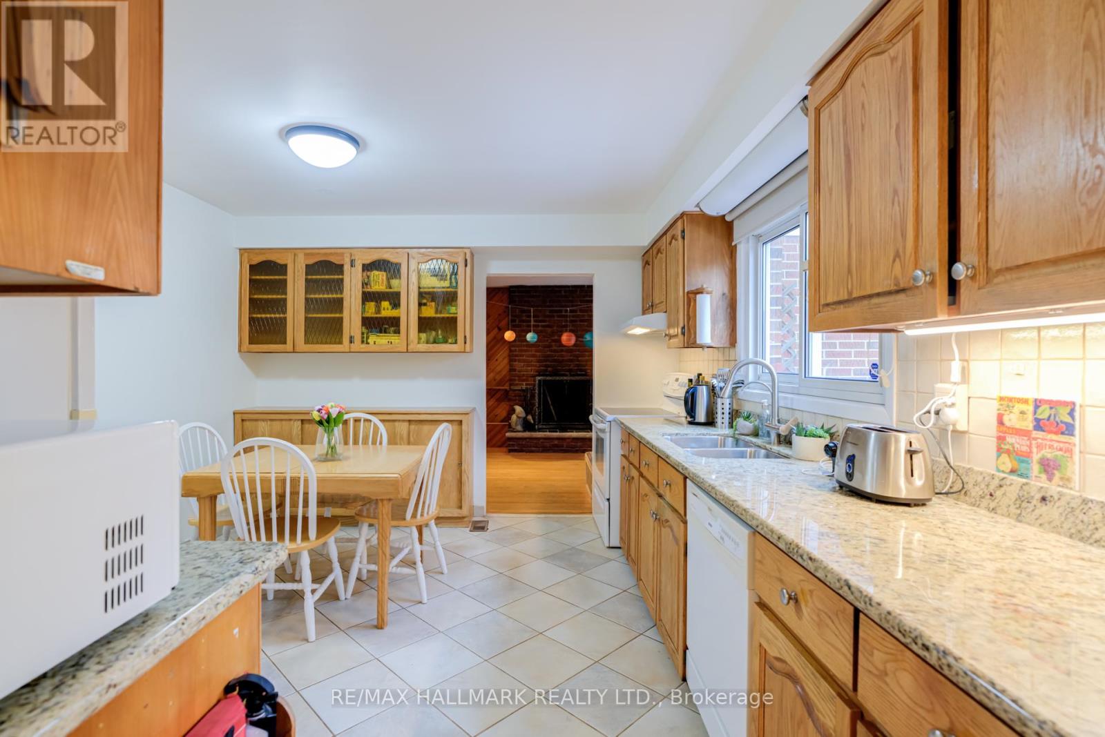 A kitchen with wooden cabinets and a table set for four.