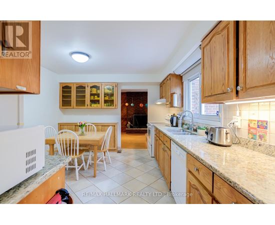 A kitchen with wooden cabinets and a table set for four.