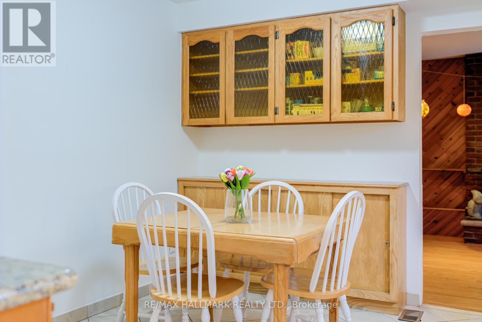 A dining room with a wooden table and chairs.