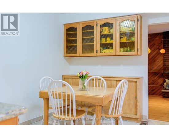 A dining room with a wooden table and chairs.