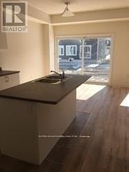 A kitchen with a sink and a window.