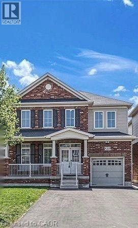 A brick house with a white door and windows.