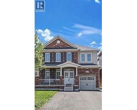 A brick house with a white door and windows.