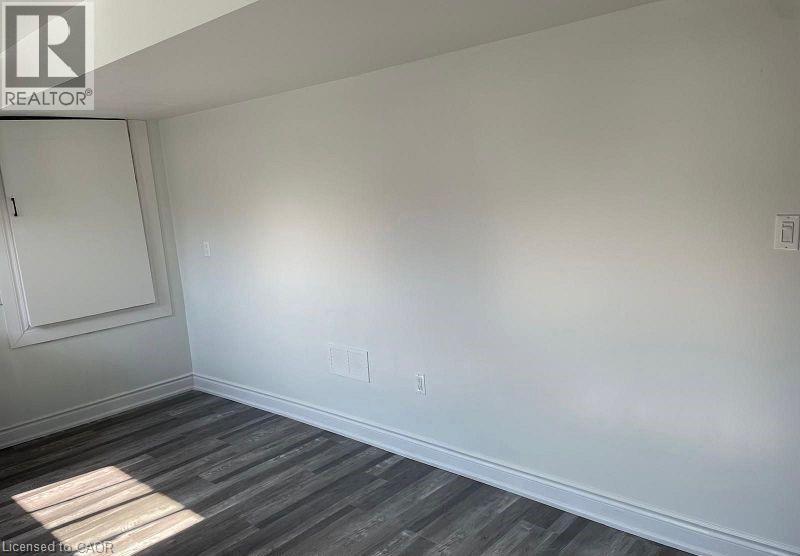 A room with a wooden floor and white walls.