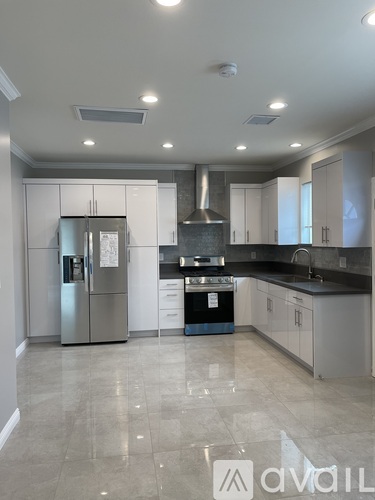 A kitchen with a refrigerator, stove, and oven.