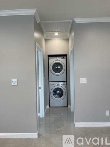 A washer and dryer stacked on top of each other in a laundry room.