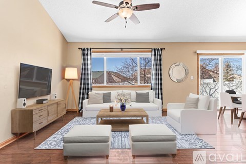 A living room with a television, a sofa set, and a coffee table.