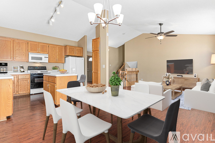 A modern kitchen with a dining table and chairs.