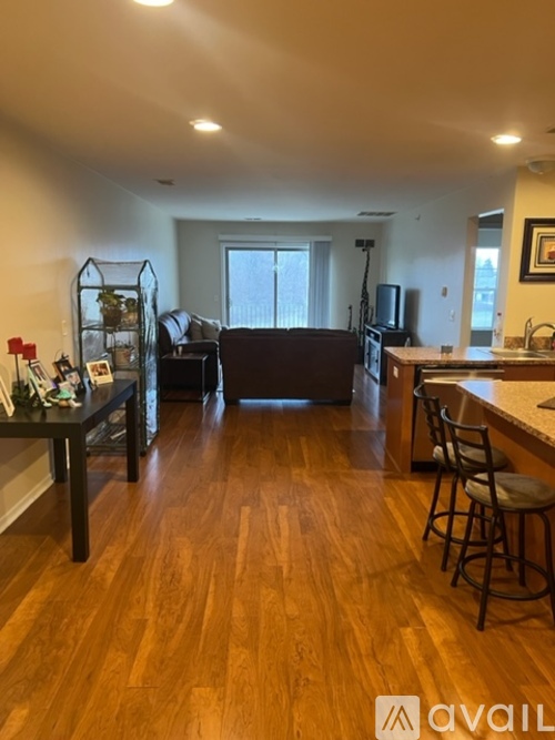 A kitchen with a bar stool and a dining table.