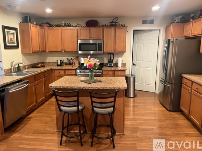 A kitchen with wooden cabinets and a granite countertop.