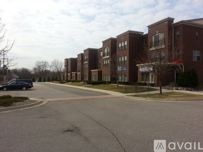 A street view of apartment buildings with a car parked on the side.