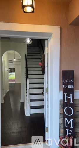 A staircase with a sign that says "Welcome to our HOME".