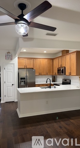 A kitchen with wooden cabinets and a white countertop.
