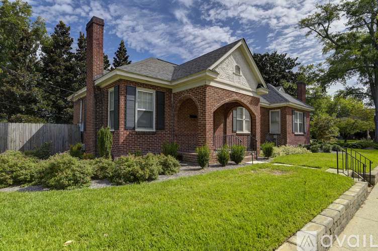 A house with a brick facade and a grey roof.