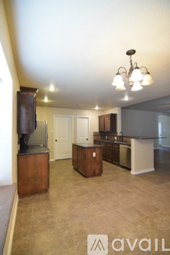 A kitchen with a brown counter and a white fridge.