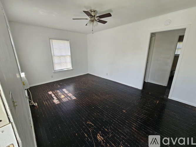A room with a ceiling fan and a window.
