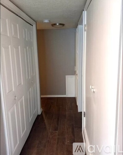A white door is on the left and a white wall is on the right.