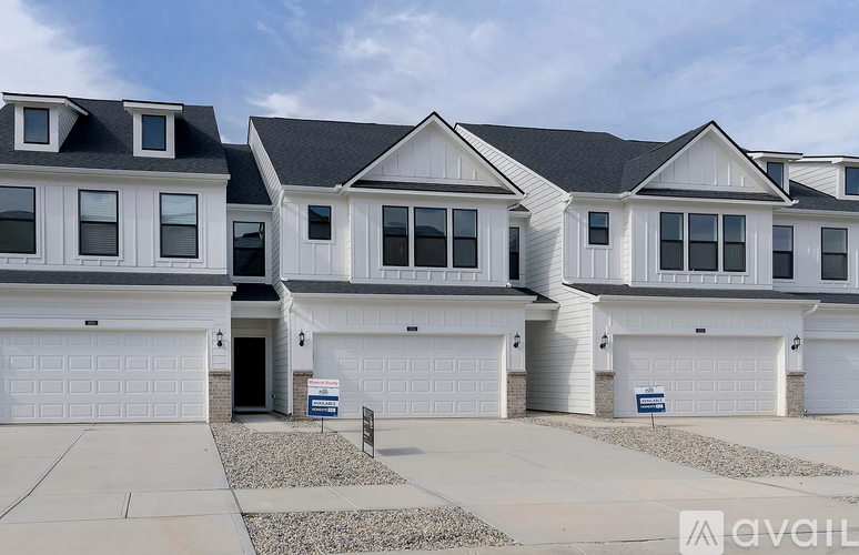 A row of houses with garages in front.
