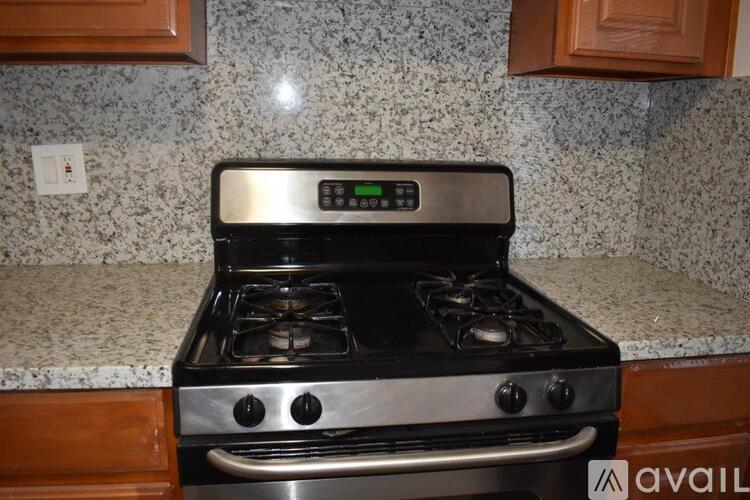 A modern stove top with a digital control panel is installed in a kitchen.