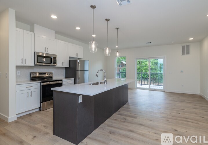 A modern kitchen with a large island in the middle.