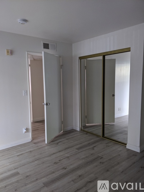 A room with a white door and a glass door.
