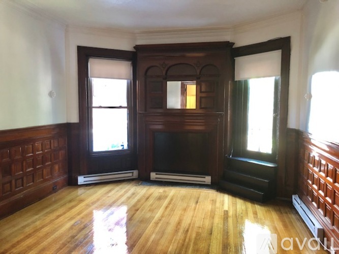 A room with wooden floors and a fireplace.