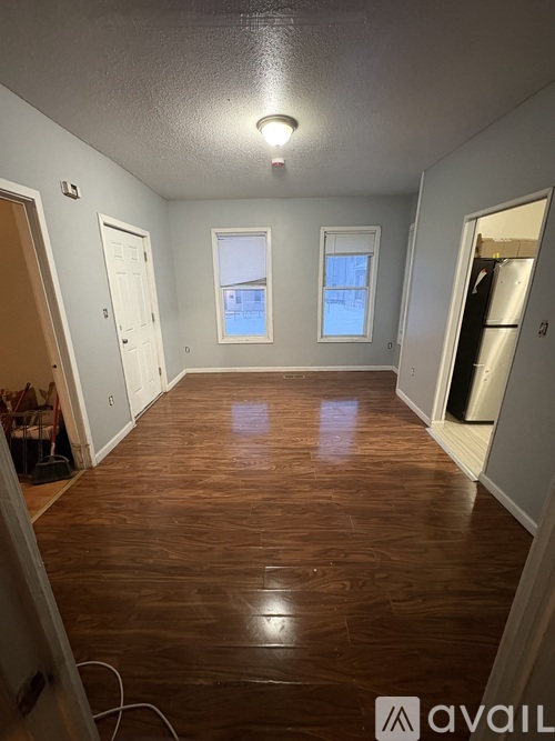 A room with wooden floors and white walls.