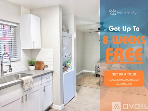 A living room with a kitchen in the background and a sign advertising a free first month for a move in special.