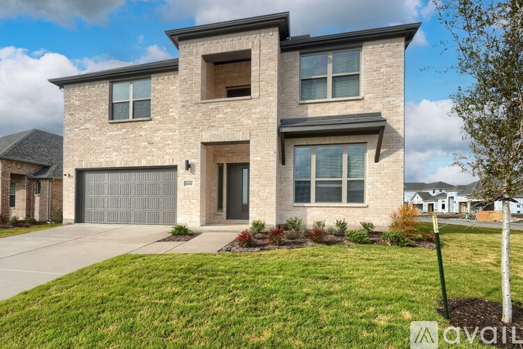 A modern two-story house with a garage is for sale.