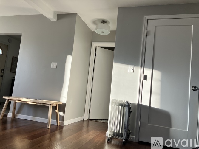 A room with a bench and a radiator.