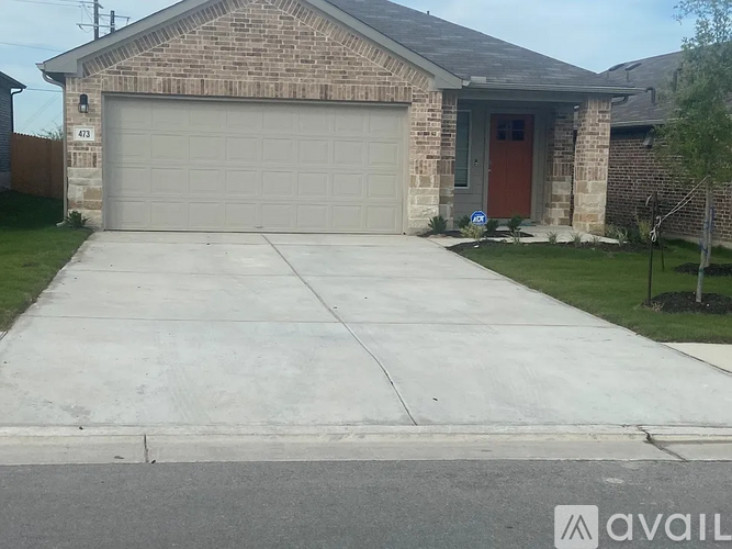 A house with a garage and a driveway in front.