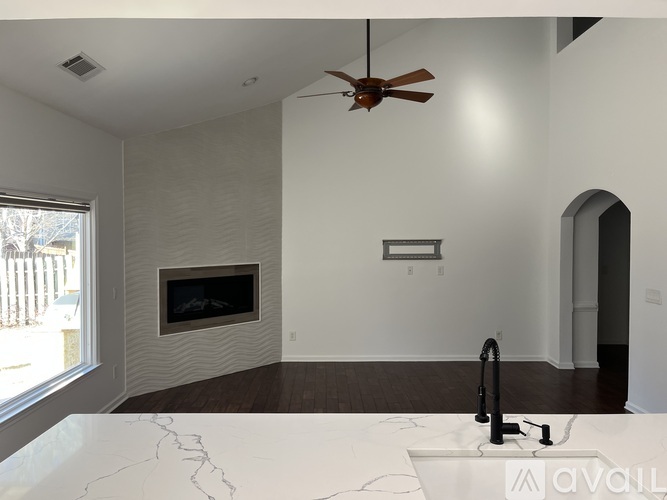A modern living room with a fireplace and a marble countertop.