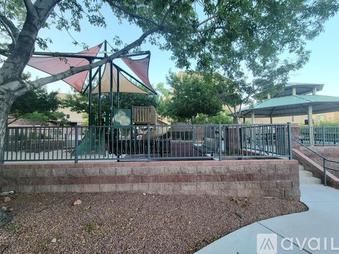 A playground with a swing set and a fence.