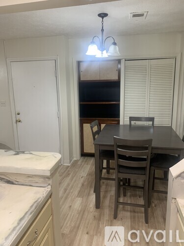 A kitchen with a table and chairs in the middle of the room.