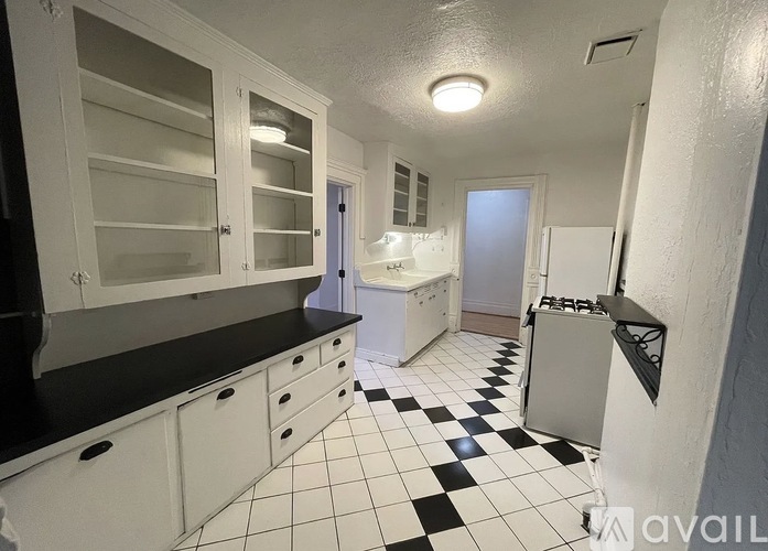 A kitchen with black and white checkered floor.