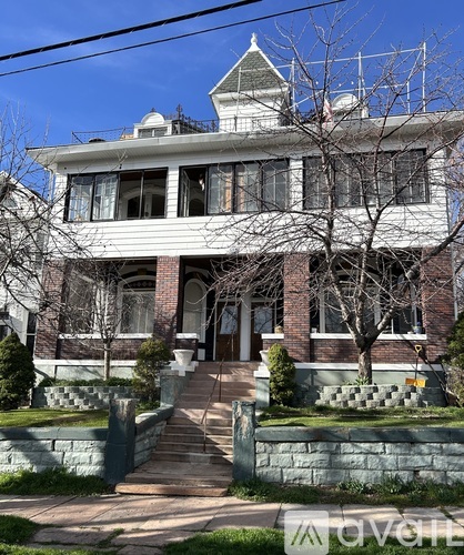 A large house with a staircase leading to the front door.