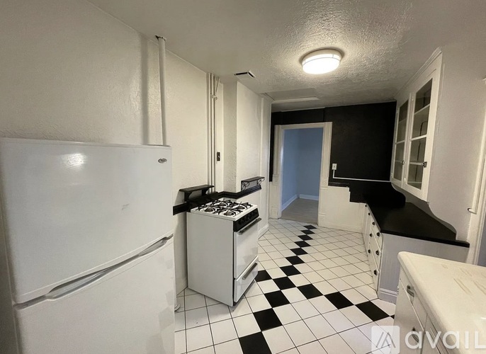 A kitchen with black and white checkered floor.