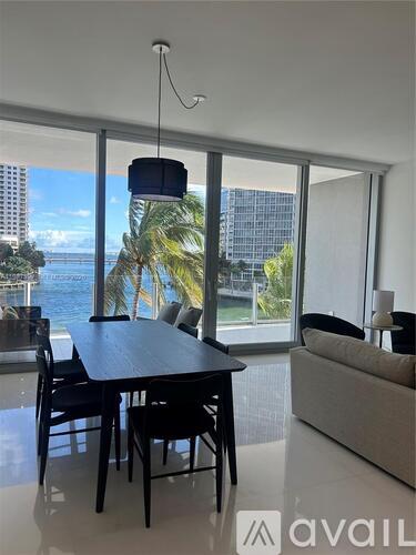 A modern dining room with a view of the ocean.