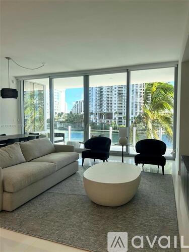 A living room with a large window overlooking a cityscape.