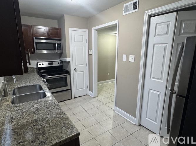 A kitchen with granite countertops and stainless steel appliances.