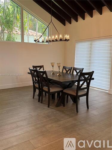 A dining room with a table set for six.